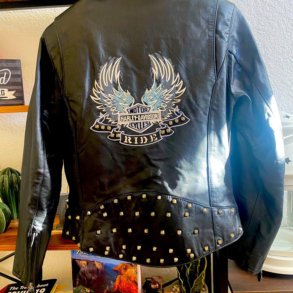 Lady’s black leather HD jacket with brass studs and embroidered eagle.